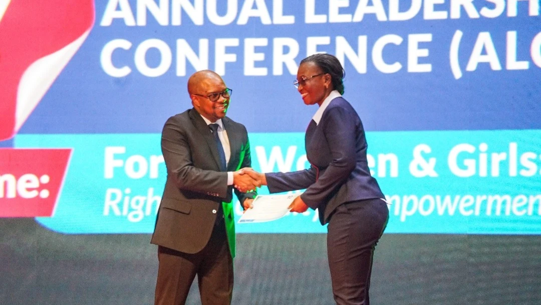 Ms. Violet Mordichai, Board Member of Stanbic Bank Tanzania, receives a certificate from Hon. Ridhiwani Kikwete during the 10th Female Future Program Graduation, recognizing the bank’s role in empowering women for leadership.