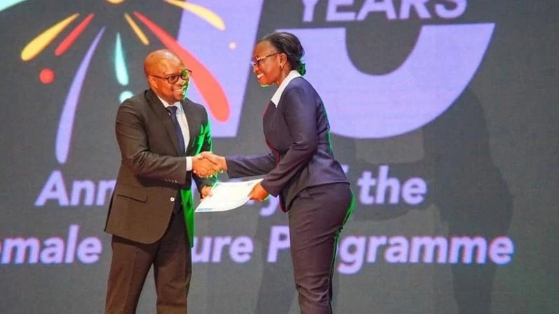 Violet Mordichai, (Right) receives a certificate from Ridhiwani Kikwete (Left) the Minister of Labour, Youth, Employment, and People with Disabilities as a recognition of the bank’s contribution in empowering women to enhance their leadership skills