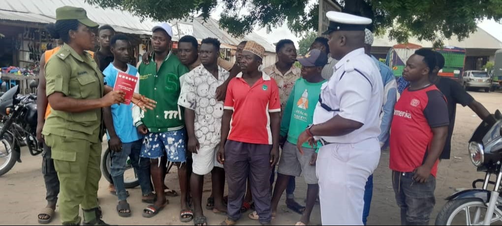 Assistant Police Inspector of Rufiji Police Special zone Faustina Ndunguru (L) and Sergeant Elirehema Mosha, provide road safety education to motorbike riders in the Nyamagwe area on Sunday. 