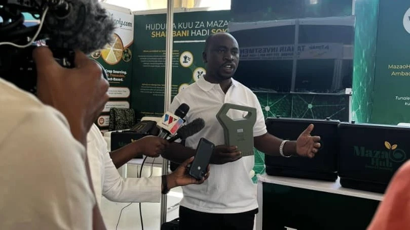 Mkurugenzi wa Mazao Hub, Geofrey Tenganamba, akizungumza na waandishi wa  habari katika maonesho ya kimataifa ya Nanenane