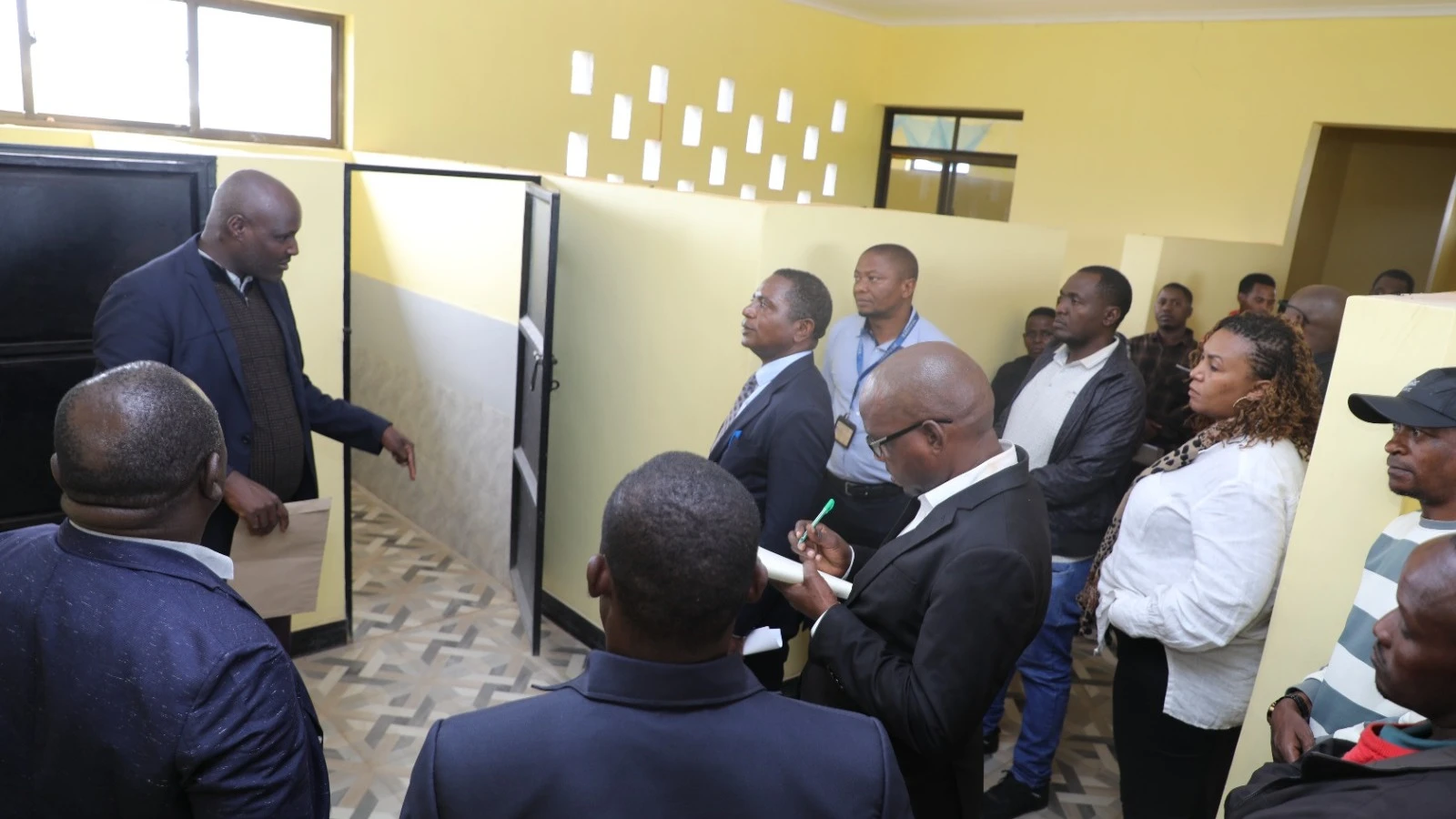  Laja Secondary School Headmaster Daniel Panga explains the girls’ dormitory project to Tasaf Executive Director Shedrack Mziray and villagers during a special visit to Laja village.