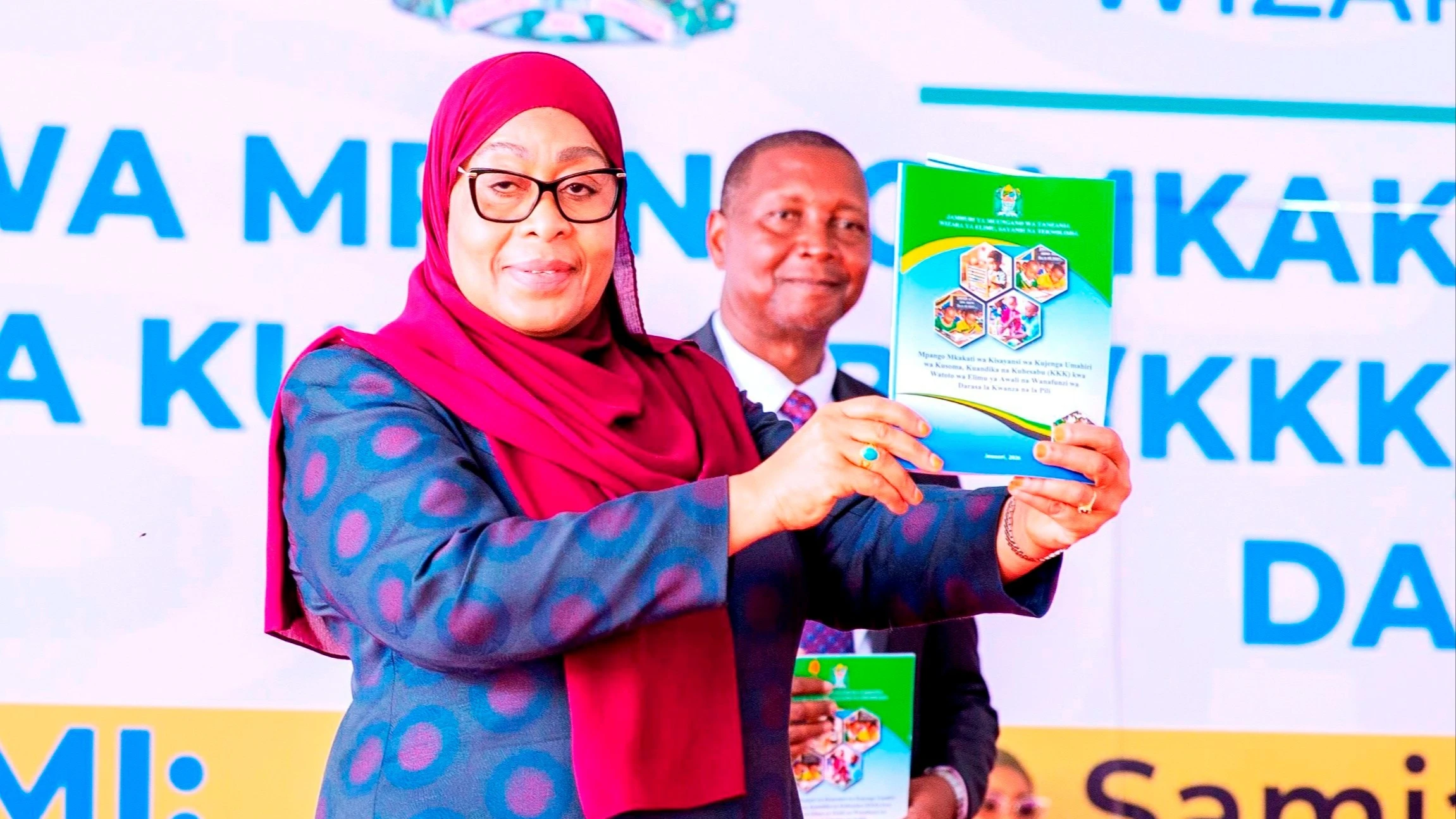 President Samia Suluhu Hassan displays the National Scientific Strategy on early-grade literacy and numeracy after its launch in Dar es Salaam, alongside Education Minister Prof Adolf Mkenda. 