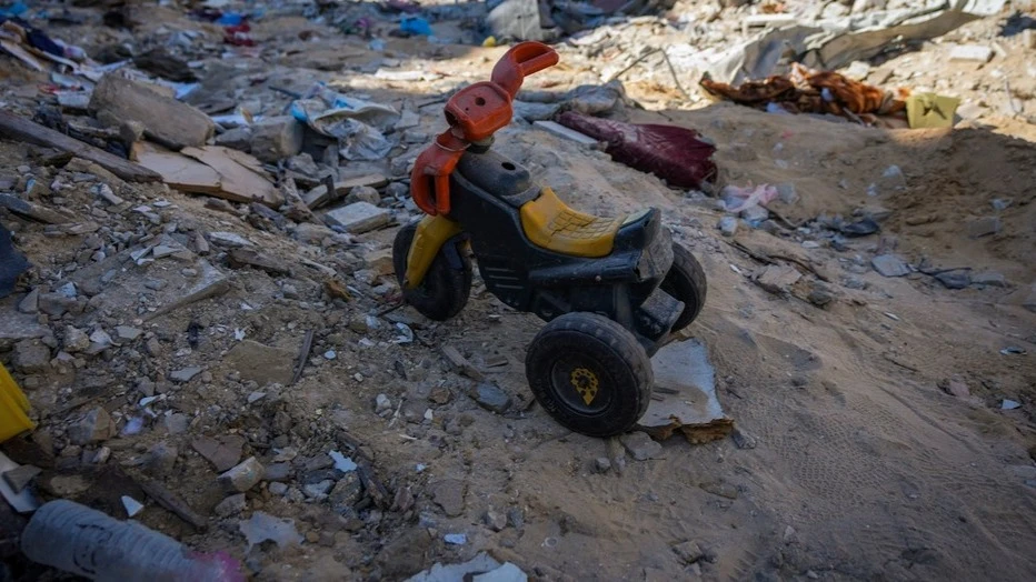 A child’s toy tricycle lies amid the rubble of destroyed homes in Rafah, southern Gaza Strip, in January 2025.