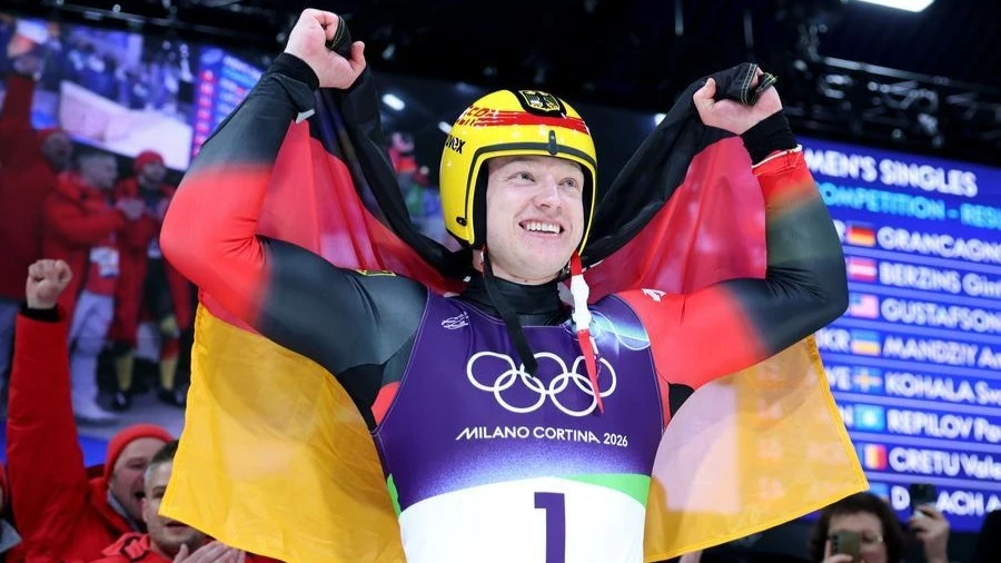Max Langenhan of Germany celebrates after the luge men's singles match at the Milan-Cortina 2026 Olympic Winter Games in Cortina, Italy, Feb. 8, 2026.
