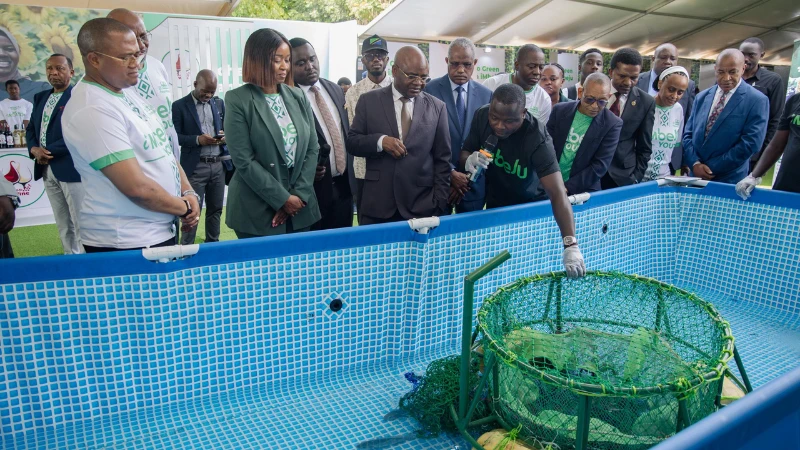 Prof Kitila Mkumbo (3rd-L, front row), Minister of State in the President’s Office (Planning and Investment), various other senior government officials, legislators and CRDB Bank executives receive explanation recently from the founder of Aquafresh. 