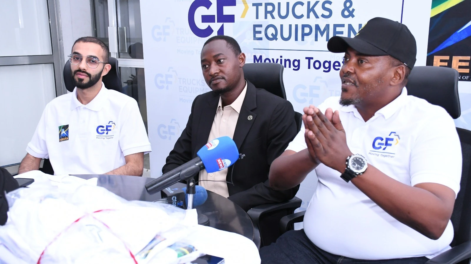 Bernard Joseph speaks at a farewell and equipment handover by GF Trucks & Equipment’s Ltd in Dar es Salaam, alongside Salman Karmali and FEMATA Secretary General Rogers Micheal Sezero.
