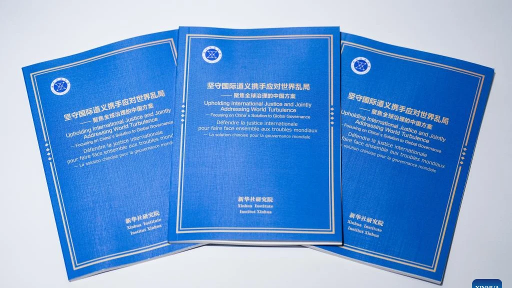 This photo shows copies of the think tank report titled "Upholding International Justice and Jointly Addressing World Turbulence -- Focusing on China's Solution to Global Governance." The Xinhua Institute, a think tank affiliated with Xinhua News Agency, 